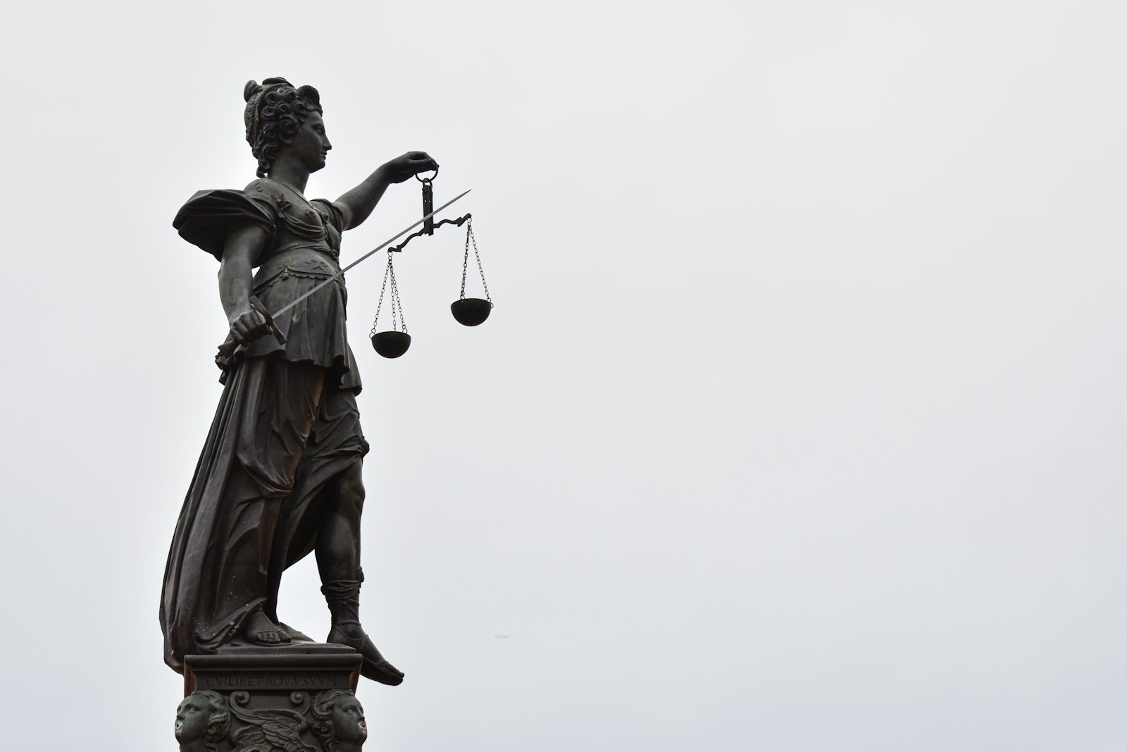 A statue of lady justice holding a scale of justice